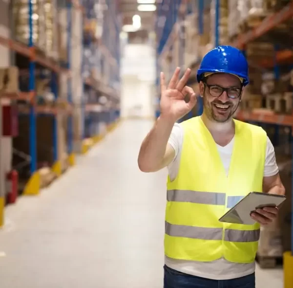 warehouse-worker-standing-large-storage-center-showing-ok-hand-gesture-satisfied-delivering-goods_342744-1526